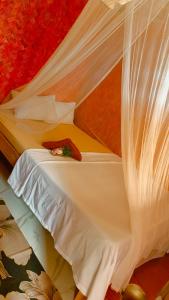 a bedroom with a bed with a canopy at Kubo Inn & Beach Camp in El Nido