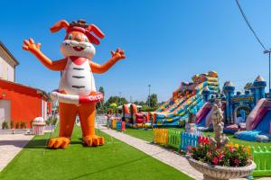 a large inflatable dog in the middle of a playground at Ciccio Hotel in Misano Adriatico