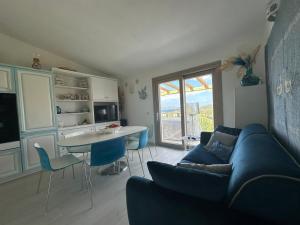 a living room with a blue couch and a table at House Hermosa Barrabisa in Barrabisa