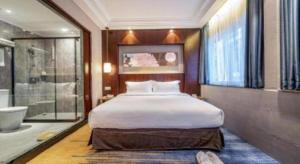 a bedroom with a large bed and a bath tub at Uniton Hotel Shenzhen in Shenzhen +91 photos
