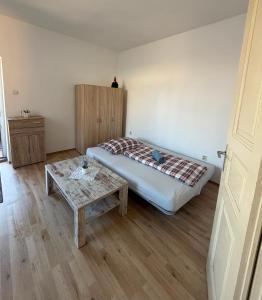 a bedroom with a bed and a coffee table at Centrum Brezno in Brezno