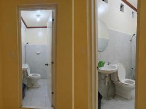 a bathroom with two toilets and a sink at Kubo Inn & Beach Camp in El Nido +61 photos
