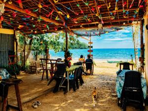 a restaurant on the beach with a view of the ocean at Kubo Inn & Beach Camp in El Nido