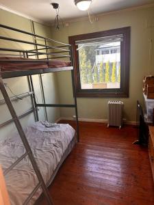 a bedroom with two bunk beds and a window at Asleep in the Valley Villa in Oslo