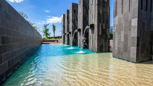 a fountain in the middle of a body of water at Residencia Nova, Jakarta in Jakarta