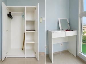 a room with white shelves and a window at Residencia Nova, Jakarta in Jakarta