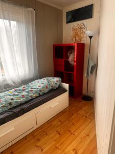 a bedroom with a bed and a red dresser at Asleep in the Valley Villa in Oslo