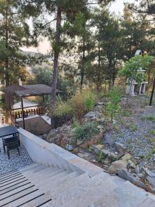 a garden with a bench and a gazebo at MAİ Sarıgerme in Sarigerme