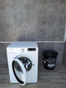 a washing machine sitting next to a trash can at MAİ Sarıgerme in Sarigerme