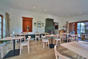 a restaurant with tables and chairs and a fireplace at Penzion Stará Vápenka in Unter Swina
