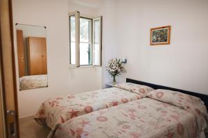 a bedroom with two beds and a window at Residence M3 in Peschici