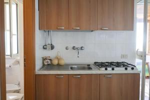 a kitchen with a sink and a stove at Residence M3 in Peschici +55 photos