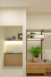 a bathroom with a sink and a potted plant at Amazing Studio Boutique Hotel in Hanoi