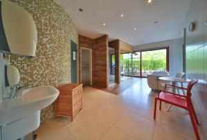 a bathroom with two sinks and a table and chairs at Penzion Stará Vápenka in Unter Swina +69 photos