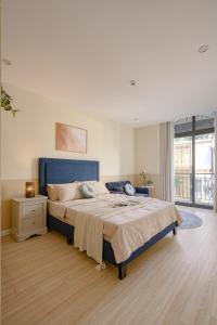 a large bedroom with a large bed and a window at Amazing Studio Boutique Hotel in Hanoi