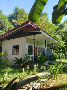 a small house in the middle of a garden at LIBYA's Guesthouse in San Juan
