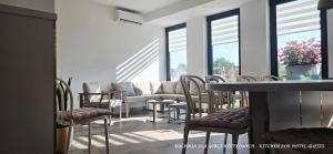 a room with chairs and a couch and windows at VENETIA-Rooms in Biecz