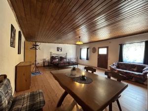 a living room with a wooden ceiling and a table at Zum Alten Pferdestall in Eppingen +6 photos