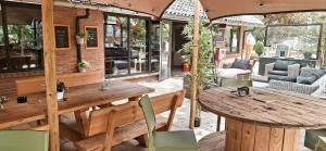 an outdoor patio with a wooden table and chairs at Happy Glamping in Wittelte