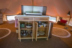 a kitchen with a counter in a tent at La Permaculturelle - Domaine des Ramières in Le Poët-Laval