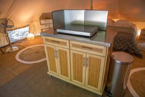a tv on a counter in a tent at La Permaculturelle - Domaine des Ramières in Le Poët-Laval +64 photos