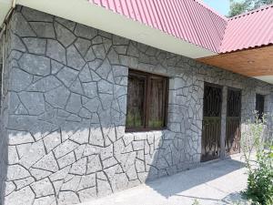 a stone house with a red roof at Moss House in Sevan
