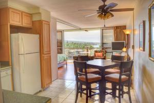 a kitchen and dining room with a table and chairs at Mana Kai 710A in Wailea