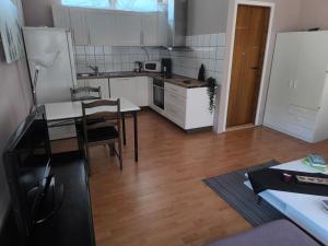 a small kitchen with a table and a dining room at Furustudio in Arendal