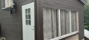 a house with a white door and a window at Furustudio in Arendal