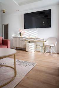 a living room with a large flat screen tv on a wall at VENETIA-Rooms in Biecz