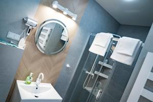 a bathroom with a sink and a mirror and a shower at VENETIA-Rooms in Biecz +43 photos