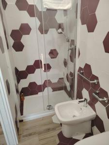 a bathroom with a shower and a toilet and a sink at OLTREMARE in Scalea
