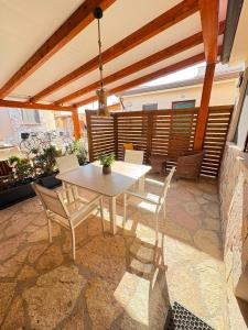 a patio with a table and chairs on a patio at Sun Tower beach apartments in Mazara del Vallo