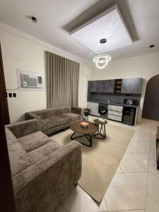a living room with a couch and a table at شقق وهل in Dammam