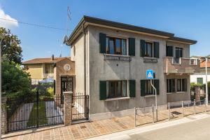 a house with a gate in front of it at Berto's house tra mare e laguna in Cavallino-Treporti
