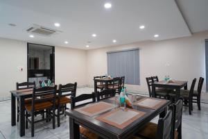 a dining room with wooden tables and chairs at Open Hotel by Olive - Sea Heights in Kākināda
