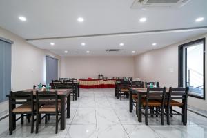 a restaurant with tables and chairs in a room at Open Hotel by Olive - Sea Heights in Kākināda