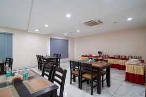 a dining room with tables and chairs and tablesktop at Open Hotel by Olive - Sea Heights in Kākināda +24 photos