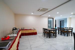 a dining room with a table and chairs at Open Hotel by Olive - Sea Heights in Kākināda