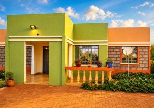 a green house with a bench in front of it at Grace bnb Marsabit in Marsabit
