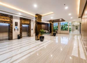 a lobby with a marble floor and large windows at Loft Privato, Jakarta in Jakarta +12 photos