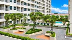 an apartment courtyard with trees and a building at Loft Privato, Jakarta in Jakarta