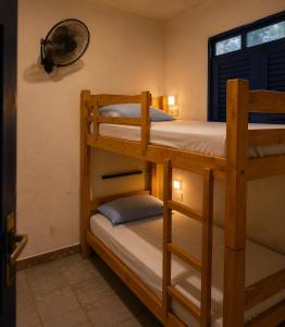 two bunk beds in a room with a window at Armorial Hostel in João Pessoa +20 photos