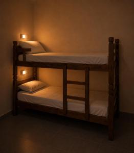 two bunk beds in a room with lights on them at Armorial Hostel in João Pessoa