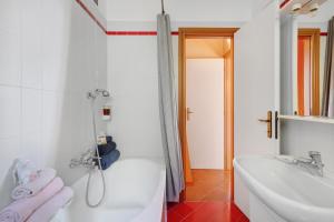 a white bathroom with a tub and a sink at Bellagio House Antico Ulivo in Bellagio +30 photos