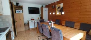 a dining room with a wooden table and chairs at Ferienwohnung Schädler in Tschagguns