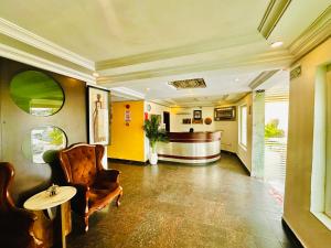 a lobby with a bar with a chair and a table at Presken Hotel K-ONE, Bank Anthony, Lagos in Ikeja +51 photos