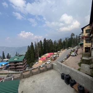 a street with cars parked on the side of a road at Hotel Aman in Nārkanda