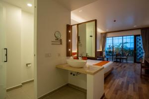 a bathroom with a sink and a bed and a mirror at Stadion Residences in Phumĭ Prêk Chrey +38 photos