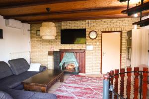 a living room with a couch and a fireplace at Villa Ferra in Virovitica +33 photos